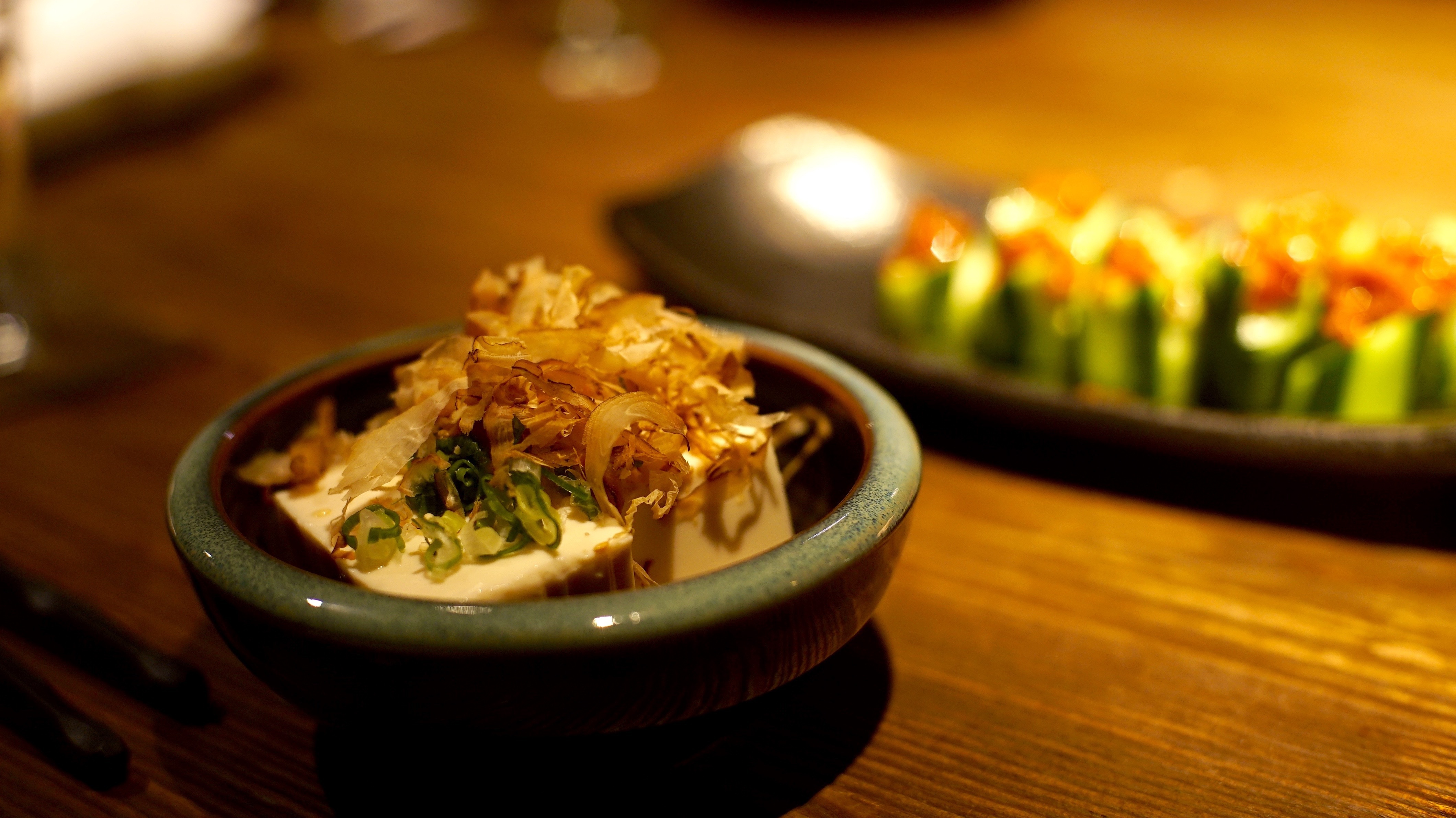 A plated dish with green garnish on a green dish